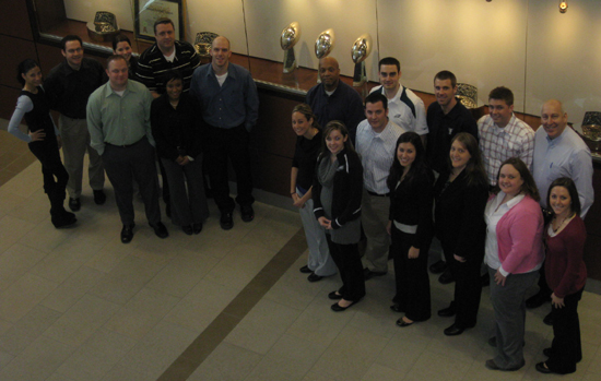 New Meadowlands Stadium IDP attendees flank the Giants three Super Bowl trophies.